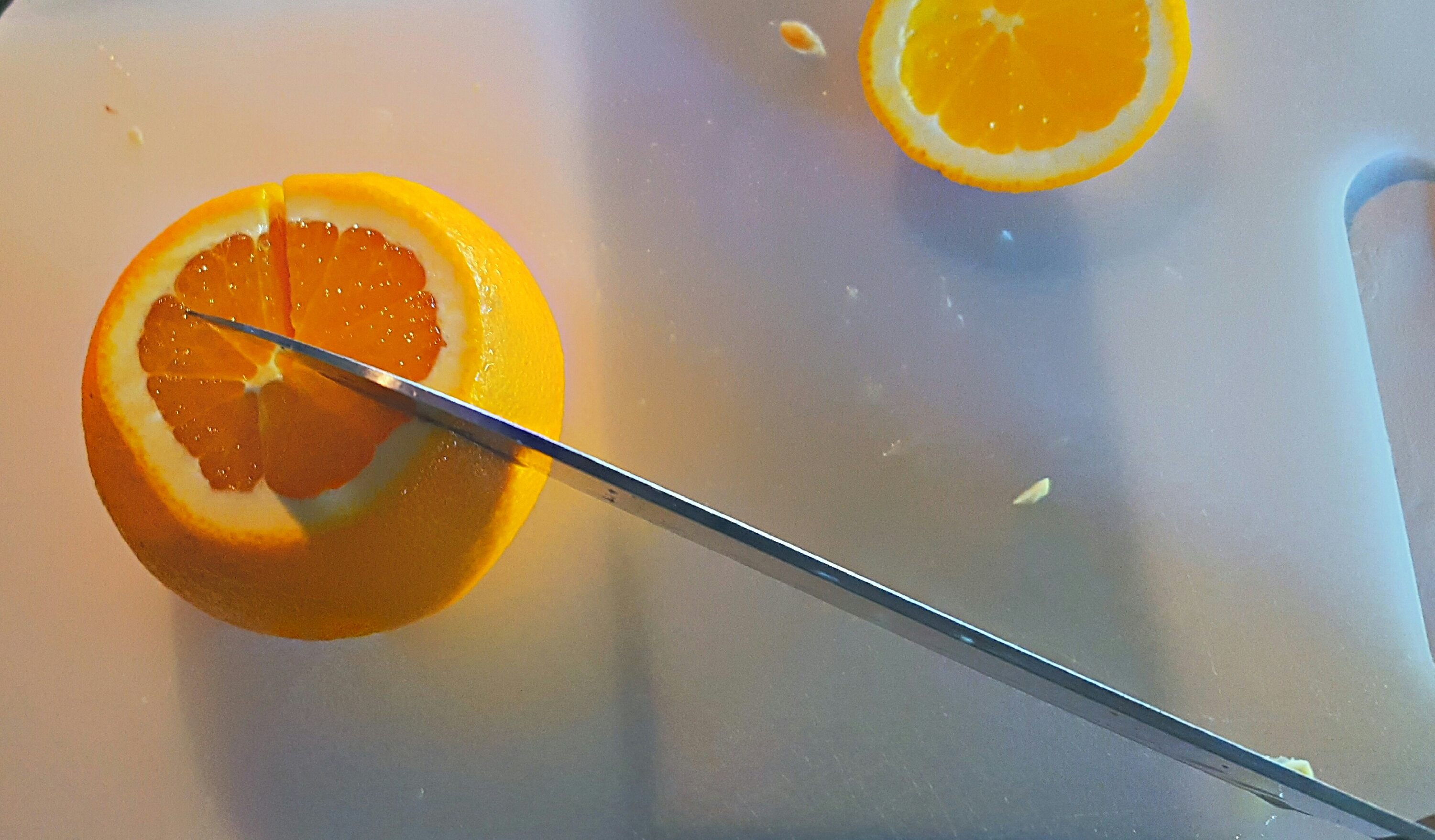 Rotate the orange 1/3rd of the way around and repeat cutting almost all the way through