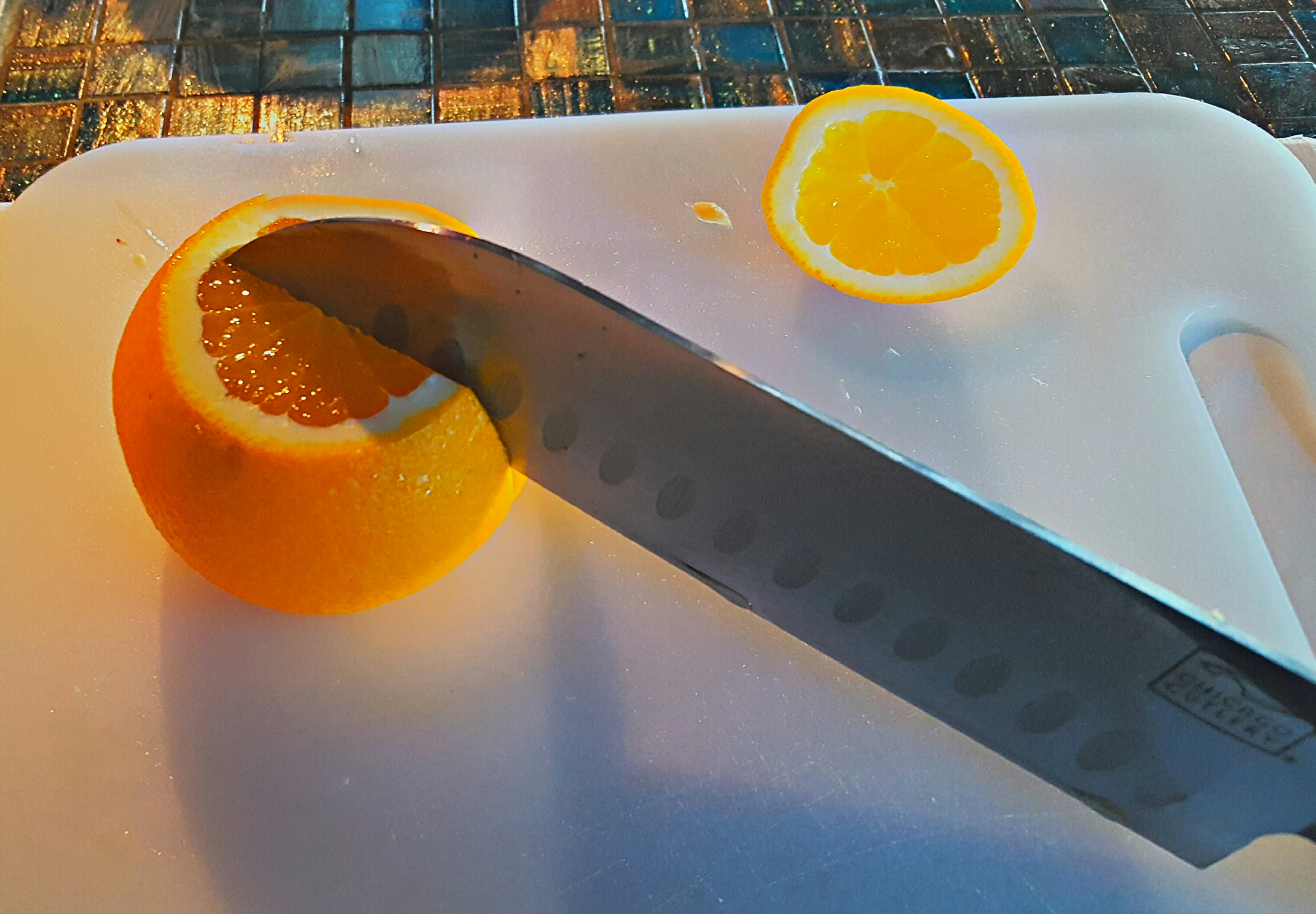 Cut almost all the way through the orange