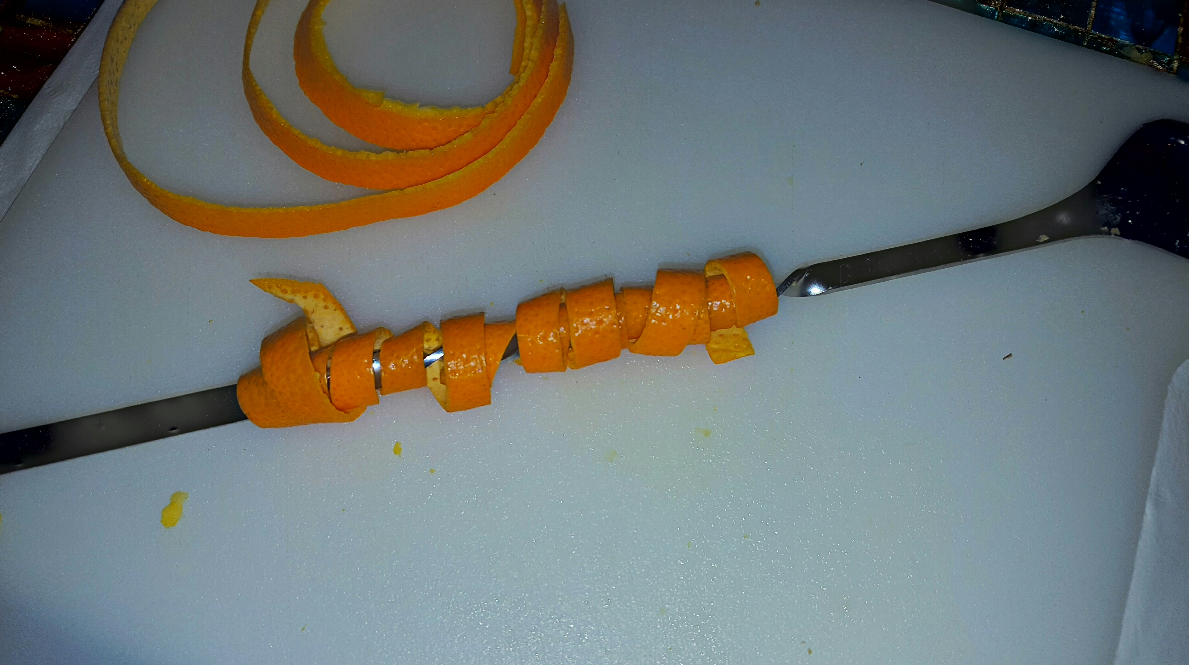 Orange skin wrapped around barspoon
