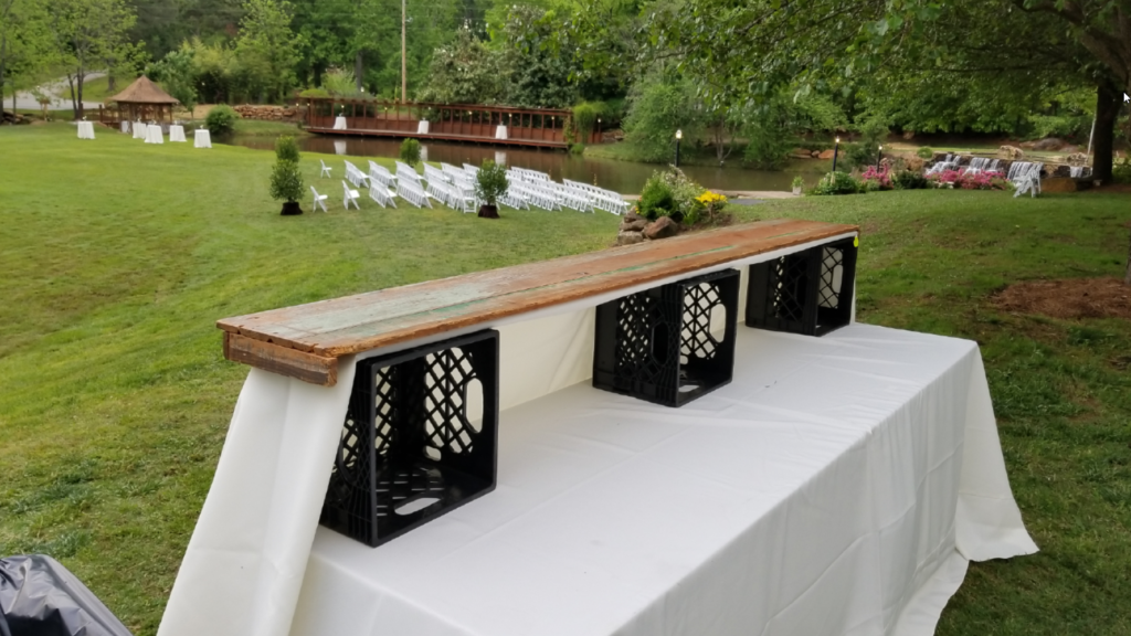 Setting up a bar for Party Bartending can be as easy as a folding table, a board, a few milk crates, and some large table cloths